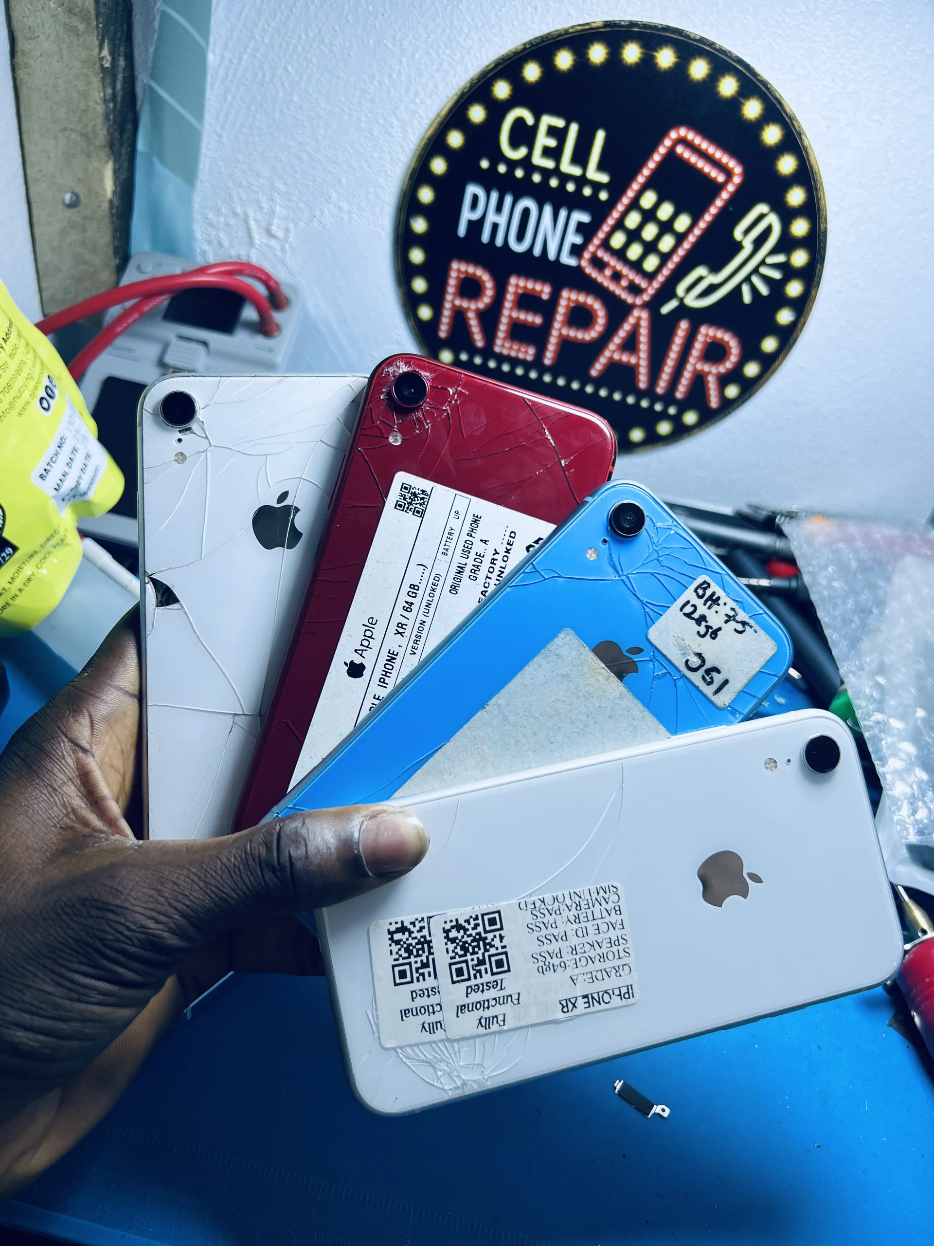 PixelFix repair counter with customer devices waiting for diagnosis